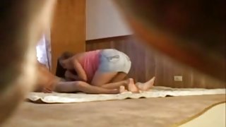 Voyeur tapes a couple having sex in various positions on the floor