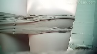 Pissing beauty is playing with her pussy in the toilet