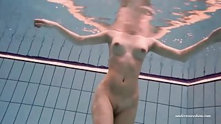 Long legged beauty underwater in the pool