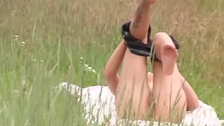 Amateur lady spreads her legs for a masturbation game in a field
