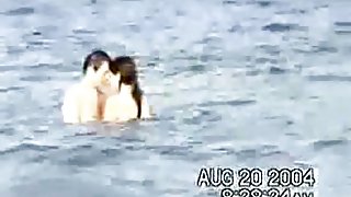 Sassy couple voyeured in the water seems to be fucking