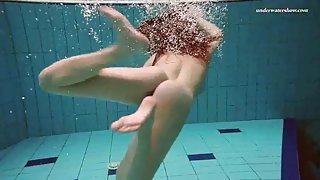 Underwater with a busty naked babe as she swims