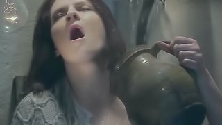 Strange brunette sits on the kitchen table and covers herself in milk before she cums