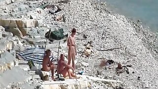 Two guys and a girl have sex on a day at the beach